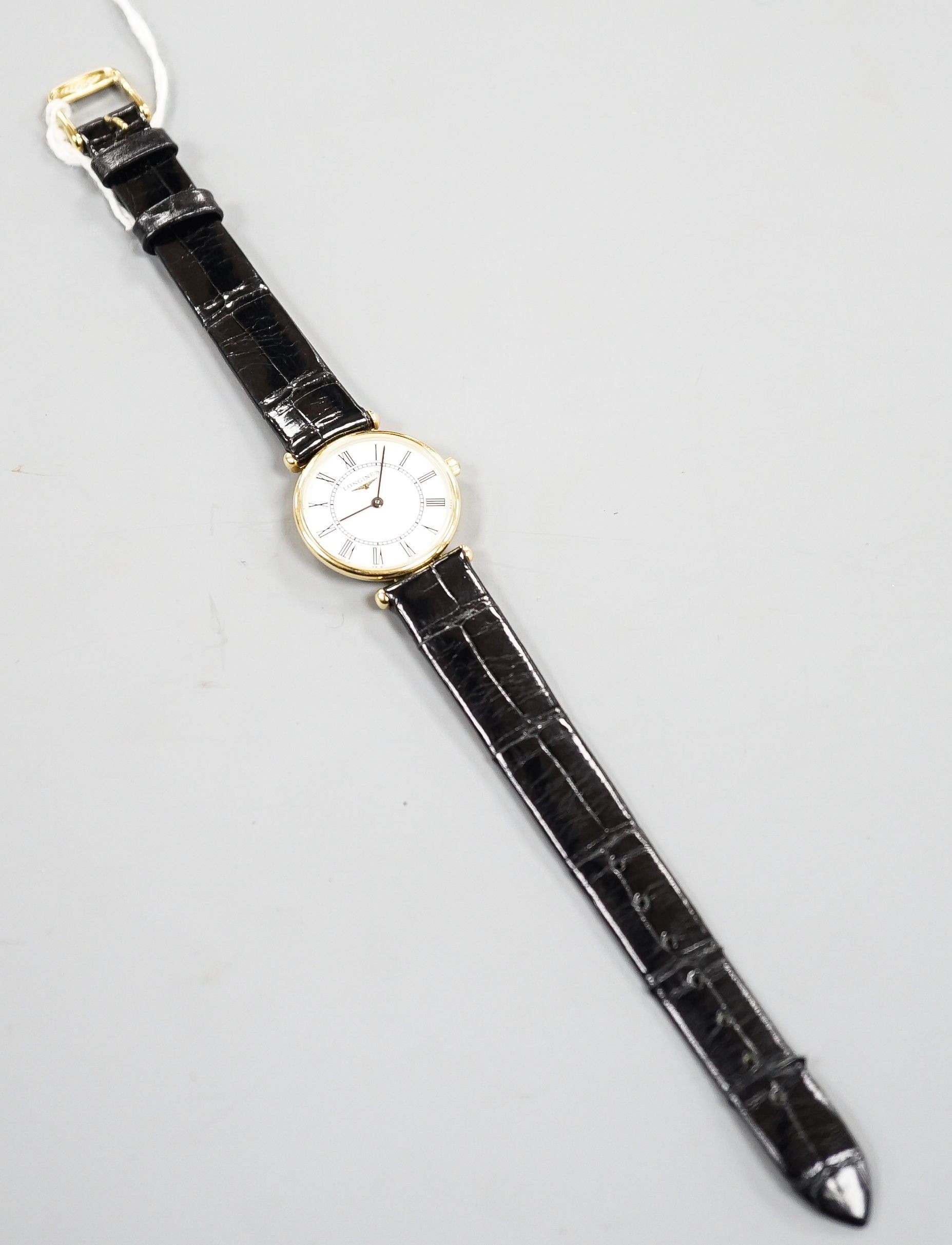 A lady's modern 18ct gold Longines Agassiz quartz wrist watch, on a Longines leather strap, case diameter 23mm, no box or papers.